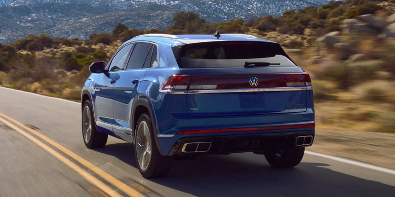 Blue SUV rear view on road