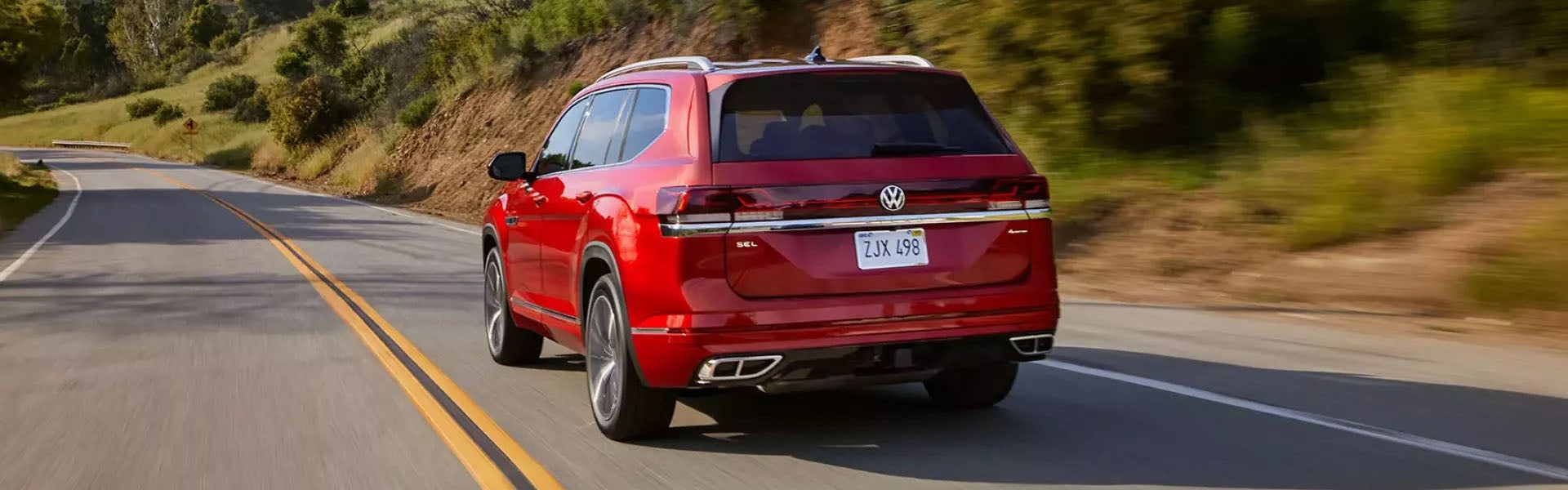 Red Volkswagen SUV driving on a highway