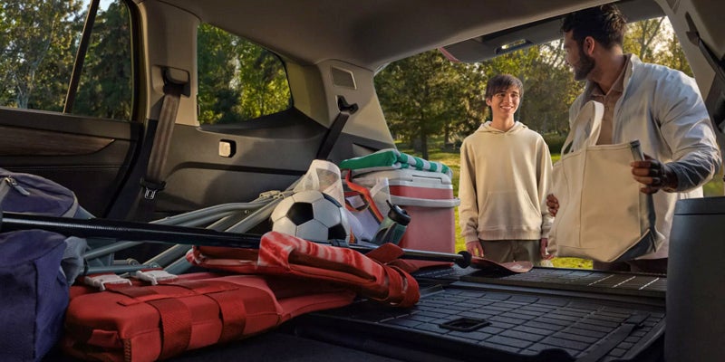 Car trunk with packed luggage and outdoor gear