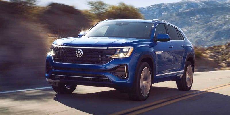 Blue Volkswagen SUV in motion on road